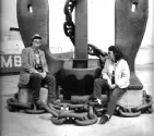 FL Decker sitting on a large anchor with Dena Decker